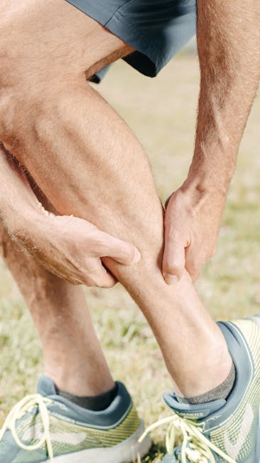 Male runner carefully stretching his leg muscles outdoors in a park